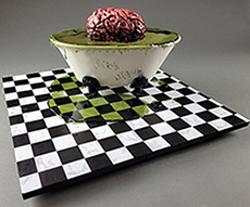 mixed media sculptural piece with a brain floating in a claw foot bath tub on a vintage tile floor o